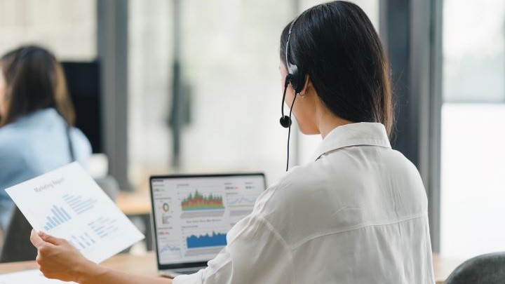 woman in call center looking at data analytics