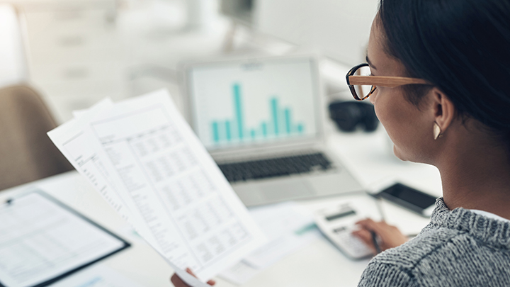 woman in office reviewing financial records