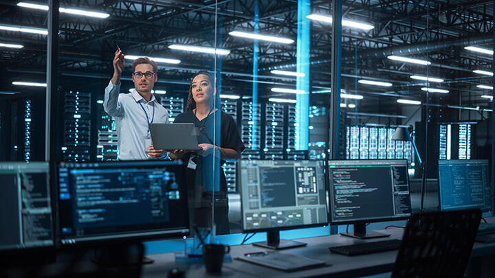 workers in managed IT service center reviewing offices