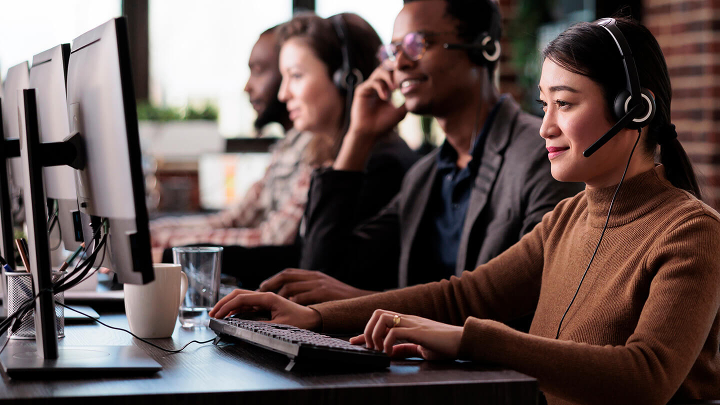 office workers in office wearing headphones in an outbound call center