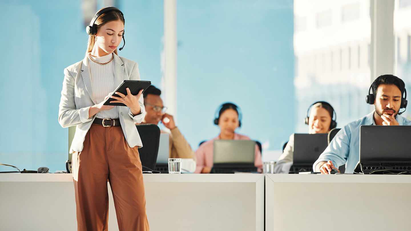 manager in outbound call center checking using tablet